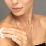 Photo of woman applying lotion on shoulder