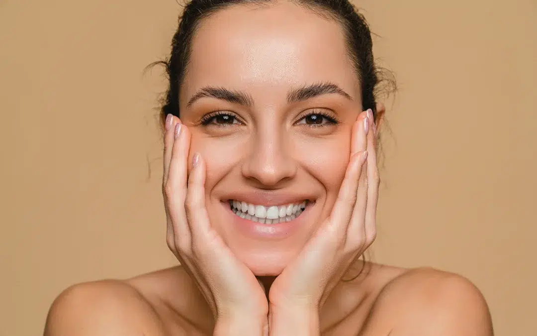 aesthetic facial and skincare cosmetic model woman touching cheeks for self love and wellness