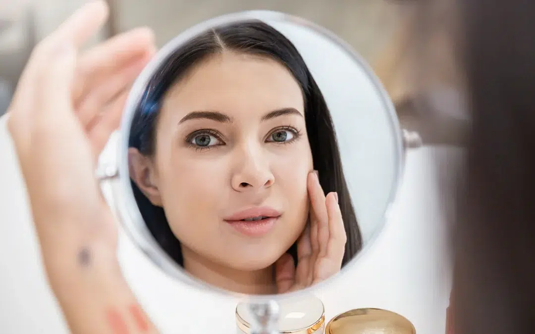 beautiful caucasian girl with mirror makeup routine