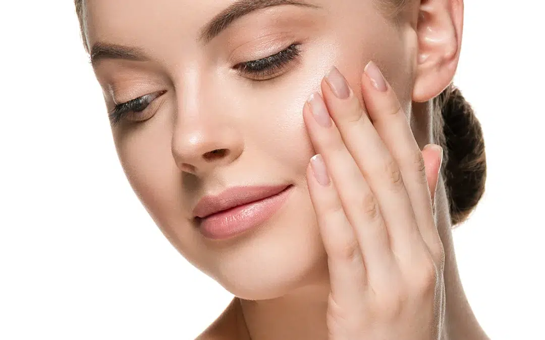 beautiful woman face hands touching cheeks with healthy clean beauty skin