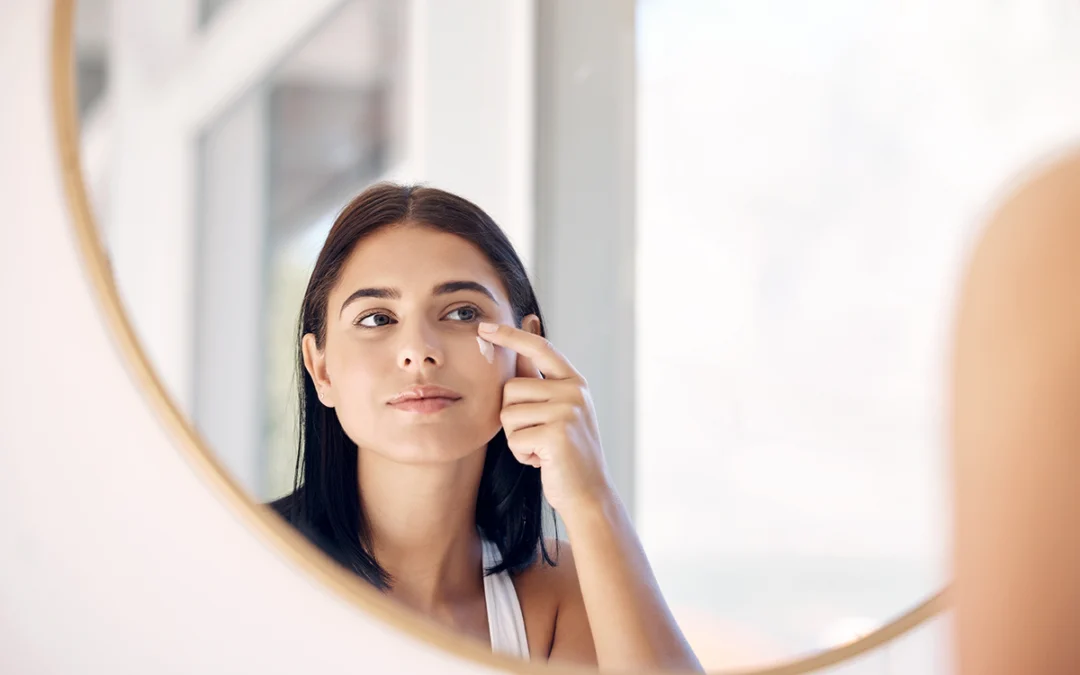 mirror reflection of woman with skincare cream