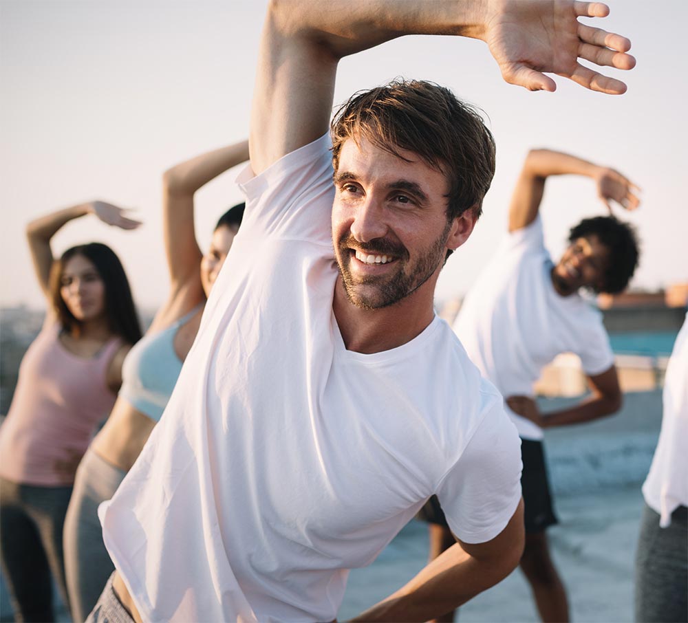 Fitness, sport, friendship and healthy lifestyle concept . Group of happy people exercising