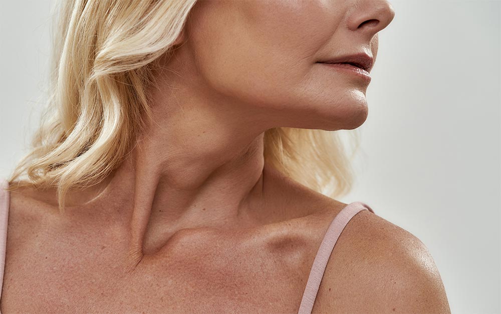Neckline and chin of middle aged caucasian woman