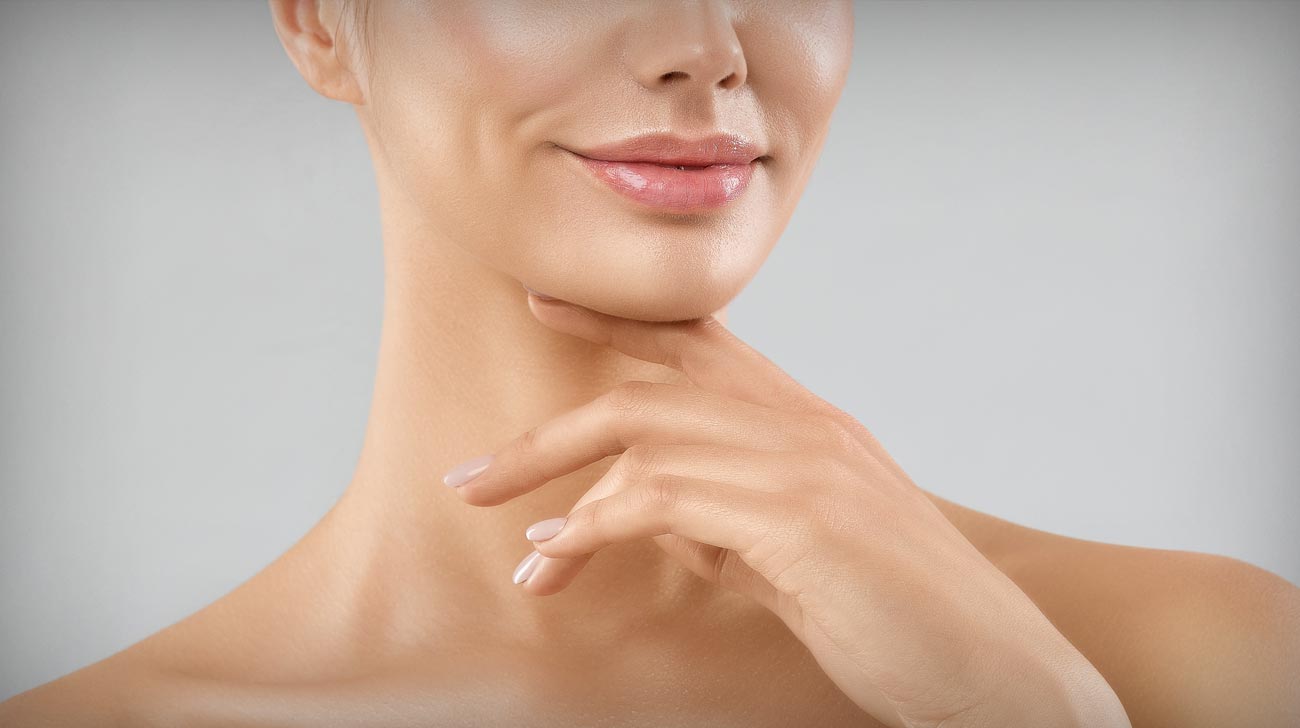 Beauty Lips Close up. Woman Chin Massage and Neck Lifting Cosmetology over White studio Background.