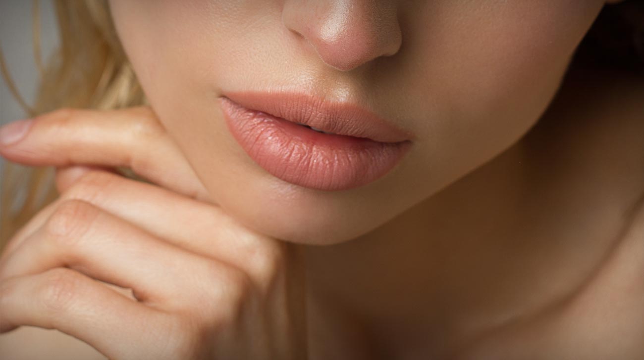 Sexual full lips. Natural gloss of lips and woman's skin. The mouth is closed.