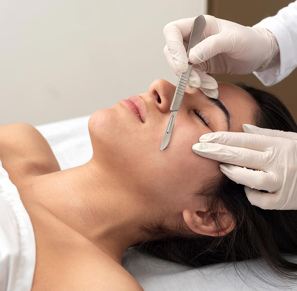 young woman on a table in a beauty center performing a beauty treatment for facial skin with the dermaplaning technique