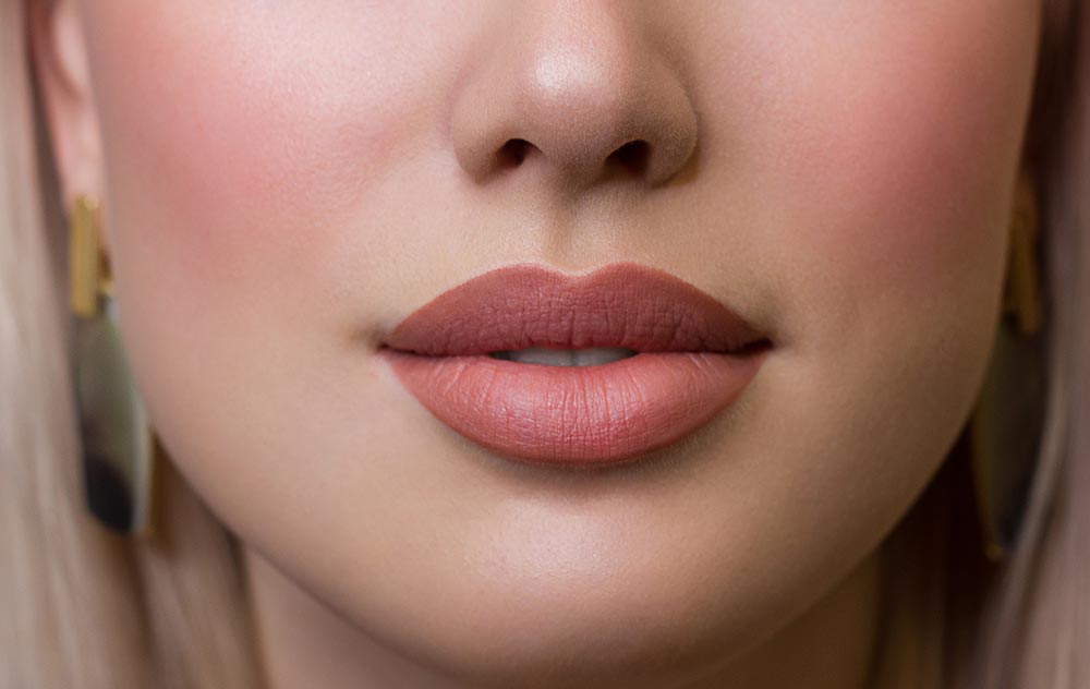 Sexual full lips. Natural gloss of lips and woman's skin. The mouth is closed. Increase in lips, cosmetology.