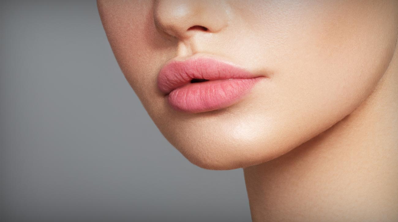 Sexy plump full lips. Close-up face detail. Perfect natural lip makeup. Close up photo with beautiful female face
