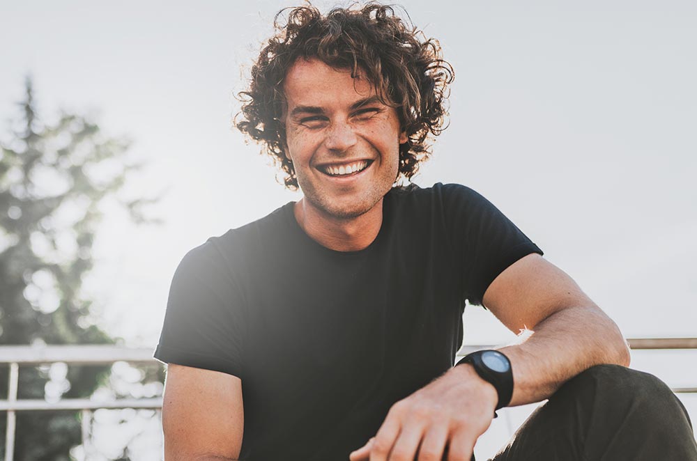Low view shot of happy stylish young man wears black t shirt