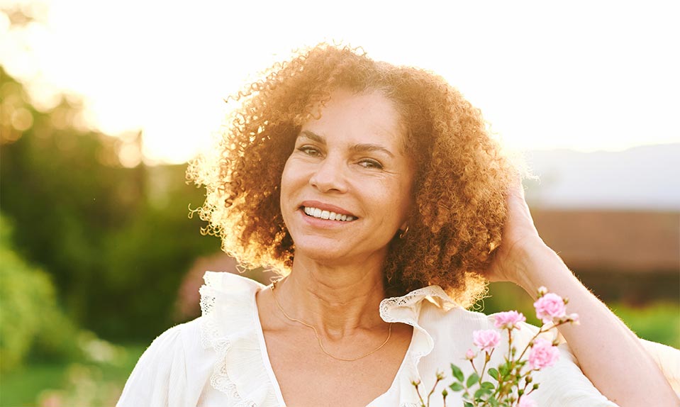 Outdoor close up portrait of beautiful middle age woman at sunset