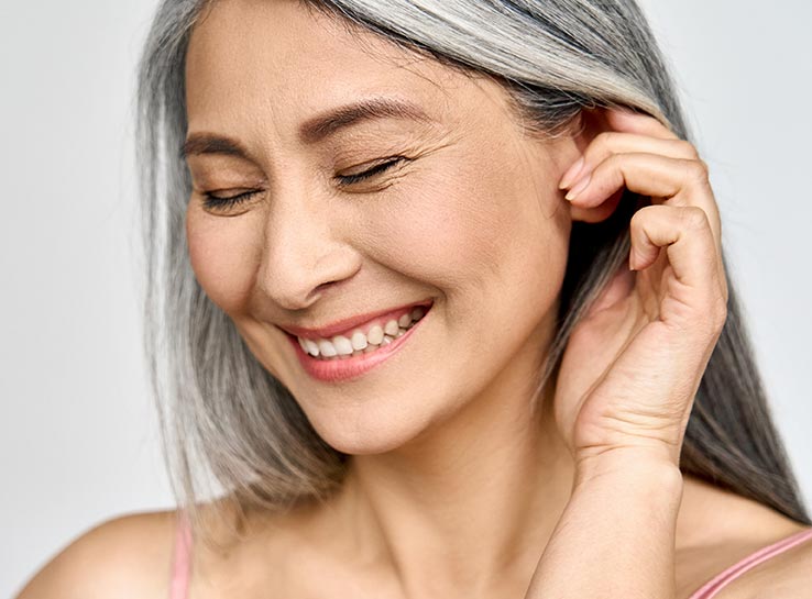 Portrait of gorgeous happy middle aged mature cheerful asian woman