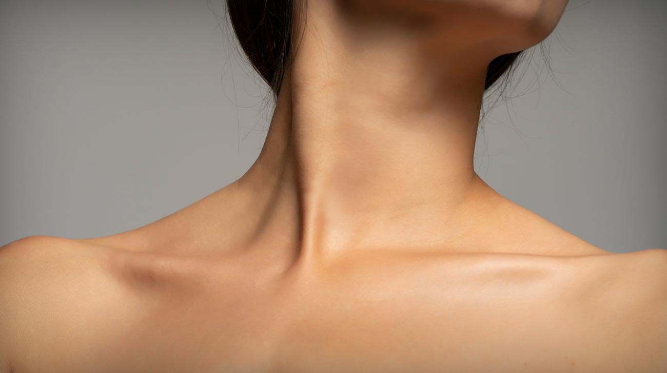 mouth, neck and bare shoulders of a smiling woman