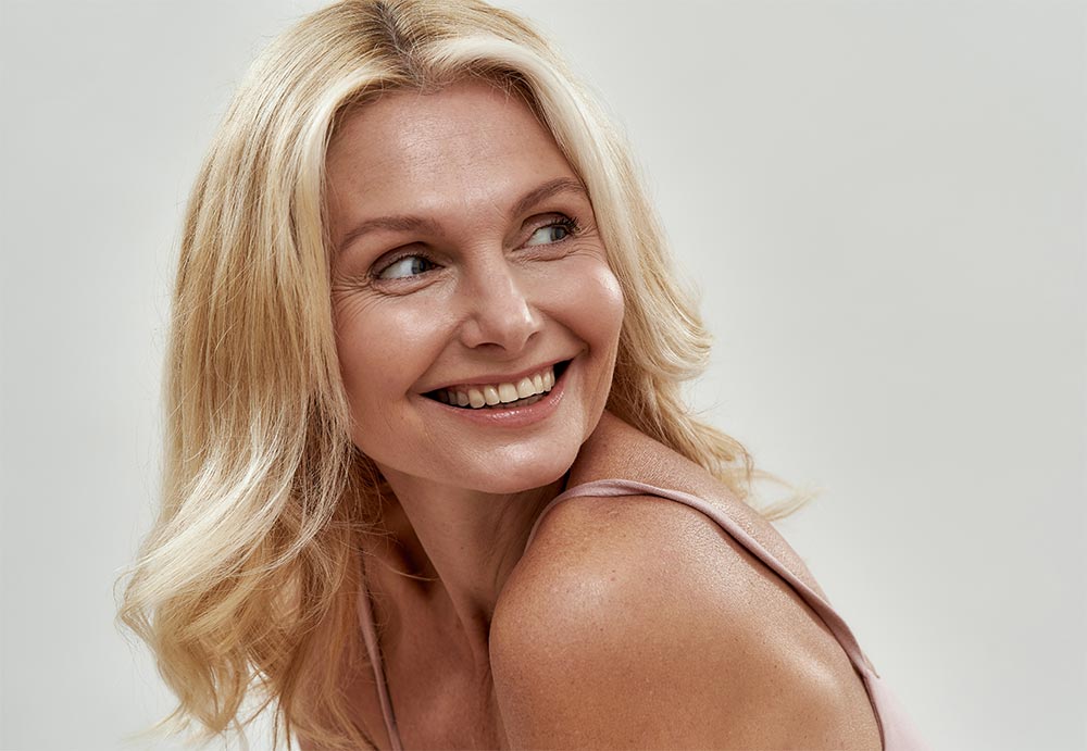 Smiling middle aged caucasian female model in lingerie