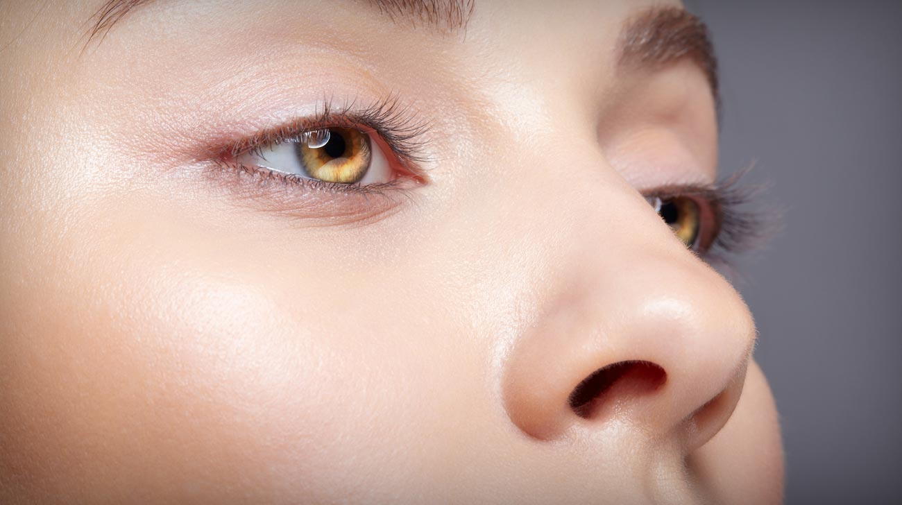 Closeup macro shot of human female eye with nude makeup.