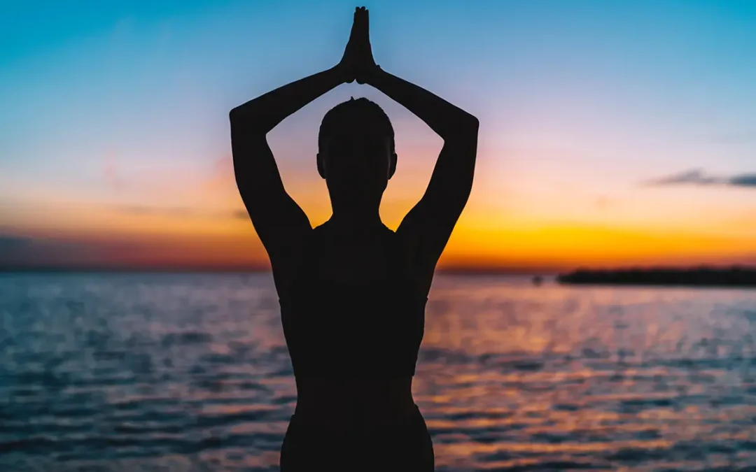silhouette of calm female reaching relaxation and inspiration during yoga practice feeling zen and recreation